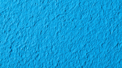 Vibrant, textured azure blue wall surface providing a striking, modern backdrop for design projects.