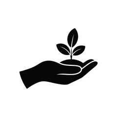 Black silhouette of a hand holding a growing plant seedling