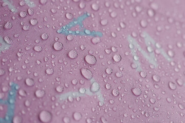Delicate water droplets glistening vibrant pink surface, showcasing fascinating wet texture....