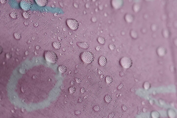 Water drop glisten vibrant pink surface, showcasing fascinating waterproof texture. clear, reflective bead create refreshing and clean aesthetic, emphasizing purity, freshness, and protection