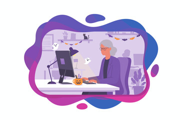 Professional senior woman working at computer in an office decorated for Halloween