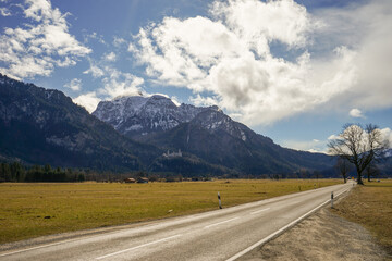 Fototapeta premium A road with a Alps mountain in the background