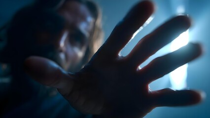 Close-up of a hand reaching toward the camera in moody blue light, fingers splayed and blurry, intense and cinematic. Concept Moody blue lighting, Hand close-up, Cinematic blur, Fingers splayed