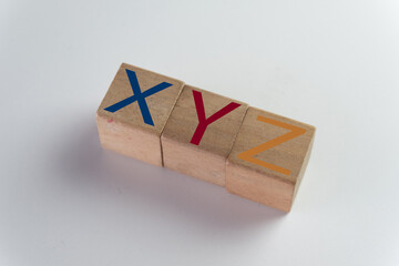 Concept of Generations X, Y (Millennials), and Z. Wooden blocks with letters XYZ representing the different demographics, the modern workforce, marketing, and social change.