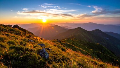 Golden hour illuminates rugged peaks, casting long shadows. A vibrant sunset paints the sky, creating a majestic natural vista