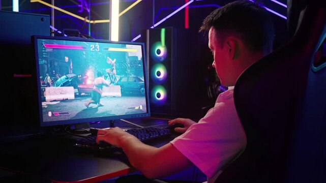 Having fun in the new combat computer game. Battling against online opponents in the combat computer game. Player destroying the multiplayer enemy to win the combat computer game round. Martial Arts.