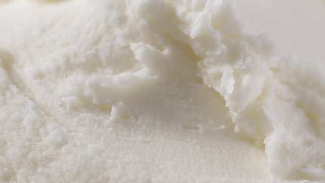 Macro view of raw shea butter texture, creamy and soft, styled close for skincare cosmetic ingredient photography concept.