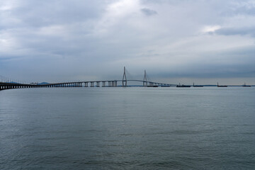 idyllic seascape with a long highway bridge