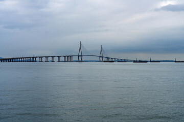 idyllic seascape with a long highway bridge