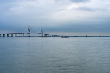 idyllic seascape with a long highway bridge