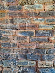 Fototapeta premium Close up of orange aged brick masonry texture suitable as a neutral background or backdrop for design projects.