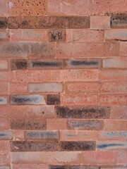Obraz premium Close up of orange aged brick masonry texture suitable as a neutral background or backdrop for design projects.