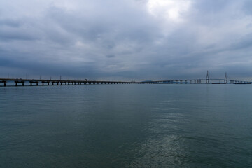 idyllic seascape with a long highway bridge