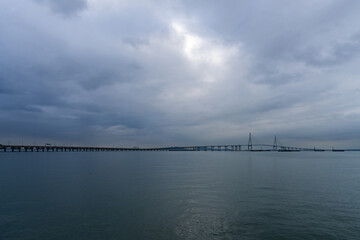 idyllic seascape with a long highway bridge