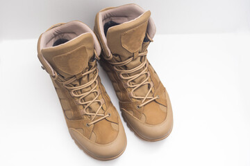 Fashion shoes with rough tread. Beige leather boots on laces for street style isolated on white background