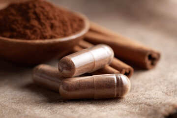 Cinnamon capsule, herbal supplement, brown powder, macro detail, natural wellness support