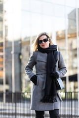 Obraz premium Young attractive business woman in front of modern business offices center.