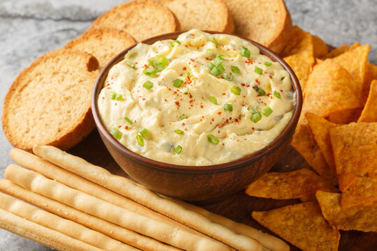 Deviled Egg Dip festive buffet appetizer with chips, breadsticks and biscuit close-up in a plate on the table. Horizontal