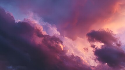 Obraz premium Dramatic pink and purple clouds fill the sky at sunset.