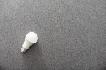 Electric light bulb on a gray background
