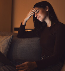 Fototapeta premium Stressed woman at late night having strong terrible headache attack after computer laptop study, sleepy exhausted girl suffering from chronic migraine massaging temples to relieve head ache tension