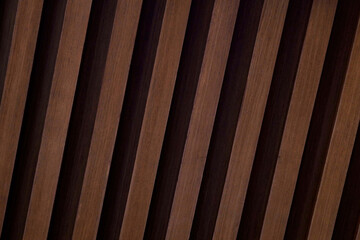 Close-up of diagonal brown wooden slats. Rhythmic fluted wood panel texture for a modern interior design background