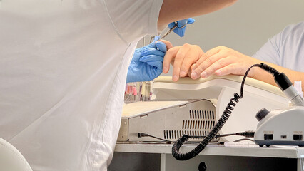 Gloved hands intricately sculpt nails, a symphony of precision, crafting elegance akin to Naadam or...