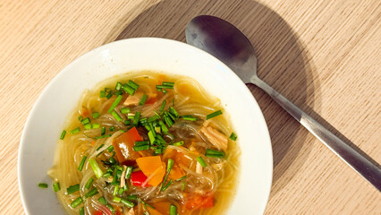Steaming pho nestles vibrant veggies, whispering tales of Lunar New Year feasts, Vietnamese culinary meditation, aromatic broth harmony