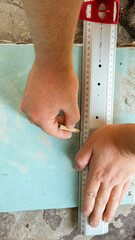 Hands of a Caucasian male meticulously measuring azure plywood, evoking Maker's Day precision and the poetic geometry of craftsmanship
