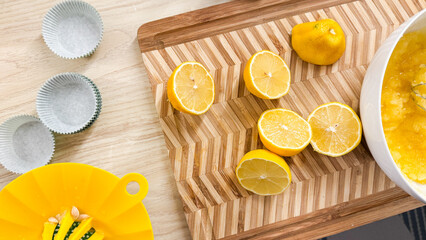Sunlit lemons on zigzag cutting board evoke zesty culinary magic, perfect for summer solstice...