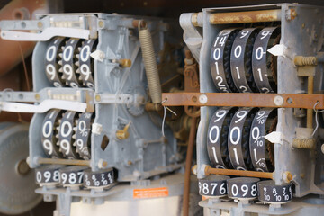 Close-up of vintage gas pump counter mechanism with metal gears and number wheels