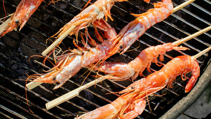 Grilled shrimp skewers sizzle with savory oceanic whispers, embodying summer solstice feasts and the vibrant Lobsterfest spirit