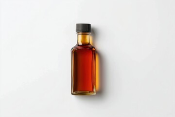 Glass bottle of maple syrup on white background in top view, flat lay composition for product mockup design, clear sharp focus with realistic texture and natural amber color details