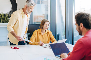 Business colleagues collaborating on strategy in modern office