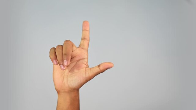 Hand Gesture Showing L Sign &mdash; Loser Gesture Close-Up on Studio Background