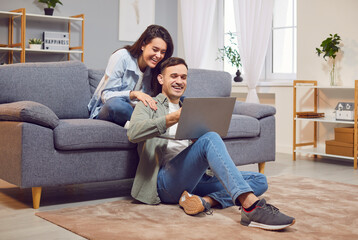 Overjoyed man and woman at home with laptop, triumph win online lottery, shopping. Happy excited young couple feel euphoric with good email, get amazing sale offer or discount deal on computer, watch