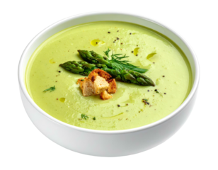 Creamy green soup with asparagus garnish and croutons in a white bowl