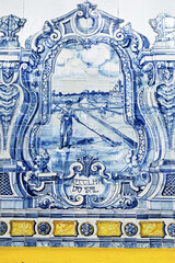 wall mural ceramic tiles, known as azulejos,  with scenes of ships, buildings, and coastal landscapes. The mural includes maritime imagery in Mercado do Livramento in Setubal, Portugal © hectorchristiaen