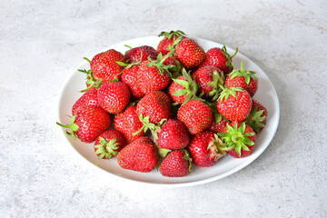 Pile of Fresh Ripe Red Strawberries on a White Plate cut out