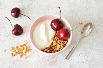 Healthy Breakfast Bowl with Yogurt, Granola and Fresh Cherries flat lay