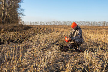 Hunter man holding first aid kit at outdoor. Hunting accident. Health problem in hunting.