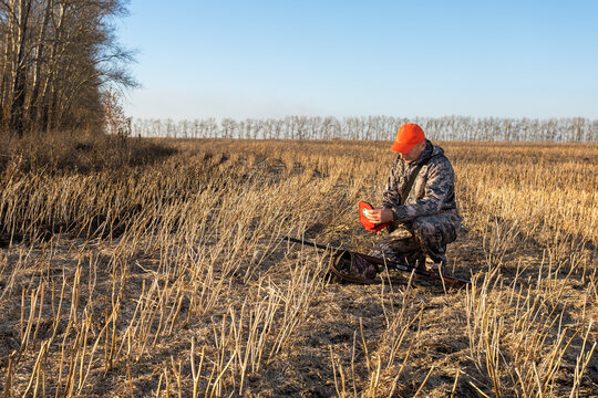 Hunter man holding first aid kit at outdoor. Hunting accident. Health problem in hunting.