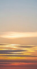 Obraz premium Abstract Sunset Over Water with Golden Hues and Soft Clouds.