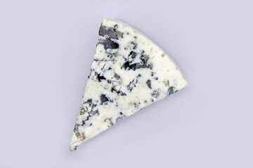 TOP SLICE OF FRACTIONATED BLUE CHEESE ON ISOLATED WHITE BACKGROUND