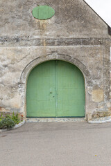 Old building archway with green wooden door in Retz, Austria