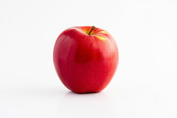 Fresh red apple on a white background showcasing vibrant color and natural shine Generative AI