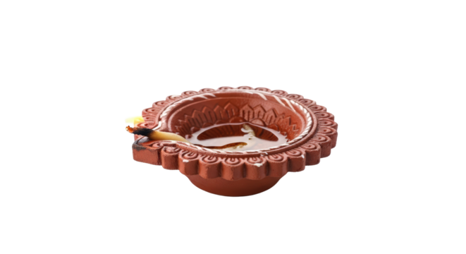 Ornate copper diya oil lamp with intricate detailing for spiritual and decorative use isolated on transparent background