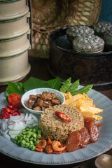 Beautifully arranged Thai shrimp paste fried rice, known as Khao Kluk Kapi, served with traditional side ingredients such as sweet pork, sliced omelet, red chili, shallots, dried shrimp, green beans, 