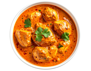 Delicious Indian dish featuring chicken pieces in a creamy, orange-hued curry, garnished