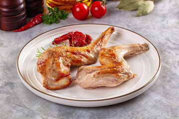 Roasted rabbit leg served rosemary